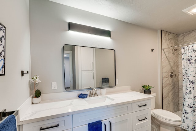 bathroom with a shower with curtain, vanity, and toilet