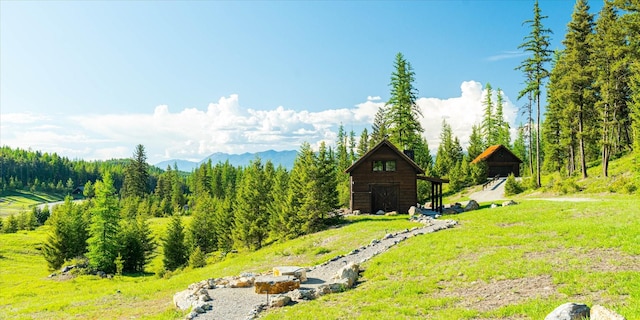 68 Wagon Trail Rd, Whitefish, MT 59937 - view of yard with an outdoor structure, a barn, and a mountain view