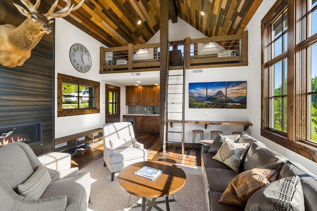 living room with wood-type flooring, high vaulted ceiling, wooden ceiling, and a fireplace