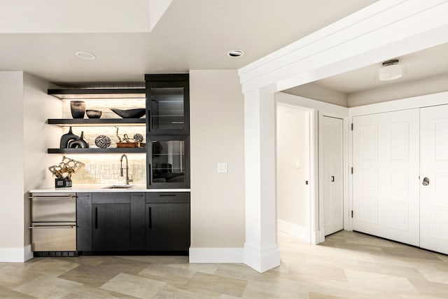 bar with tasteful backsplash and sink