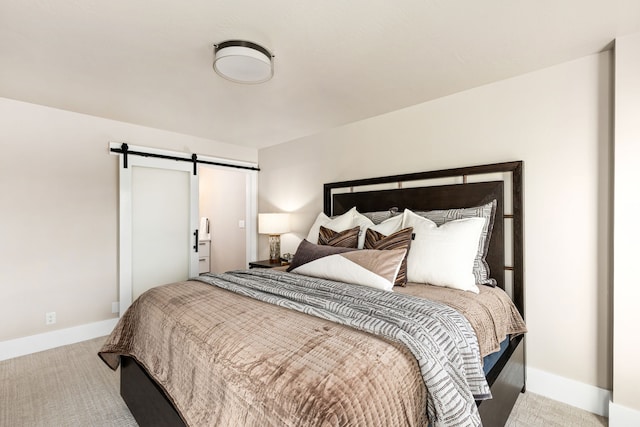 carpeted bedroom featuring a barn door