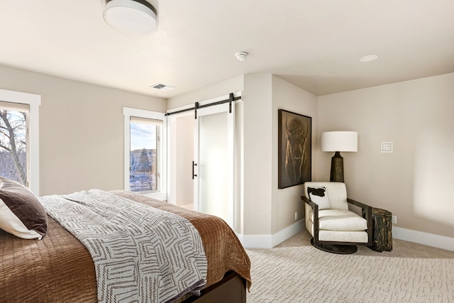 carpeted bedroom with a barn door