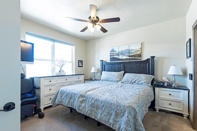 bedroom with ceiling fan, carpet flooring, and a textured ceiling