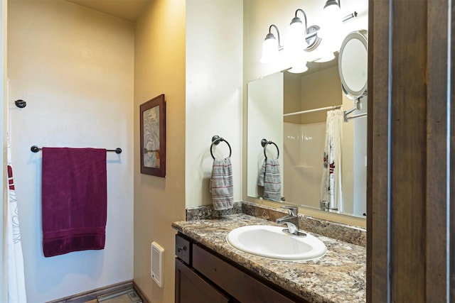 bathroom featuring vanity and a shower with shower curtain