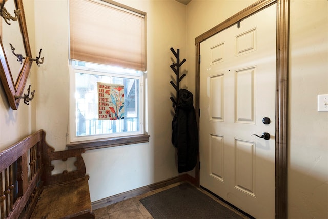 foyer entrance featuring dark tile patterned floors