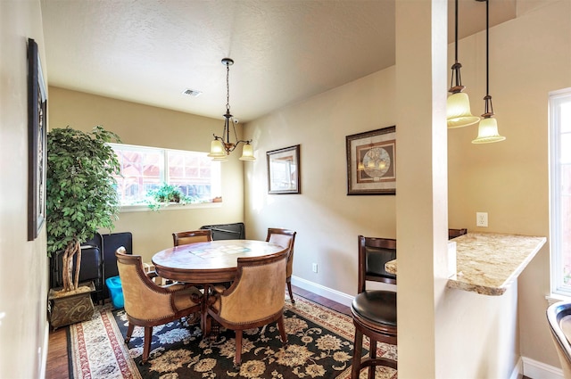 dining space with an inviting chandelier and wood-type flooring