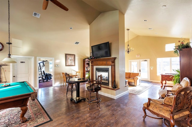 rec room featuring french doors, pool table, high vaulted ceiling, a multi sided fireplace, and dark hardwood / wood-style floors