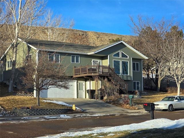 view of front of home featuring a wooden deck and a garage