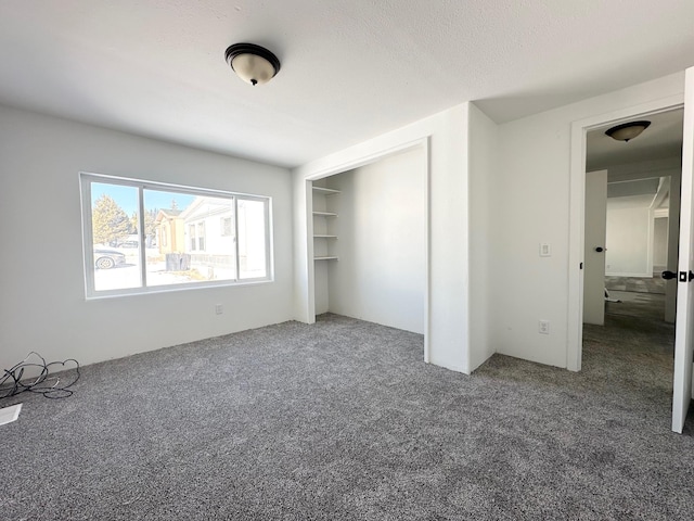 unfurnished bedroom with carpet flooring, a closet, and a textured ceiling