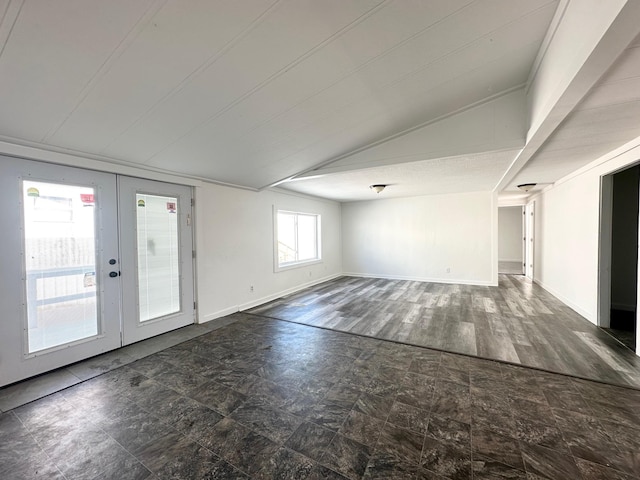 empty room with lofted ceiling, dark hardwood / wood-style flooring, and french doors