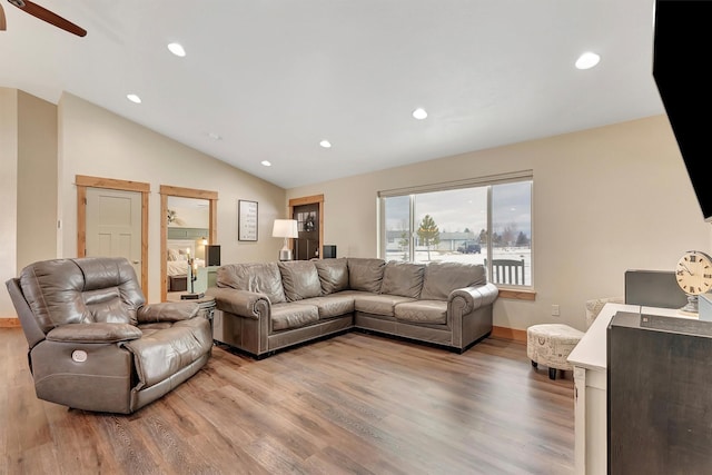 living room with lofted ceiling and light hardwood / wood-style floors