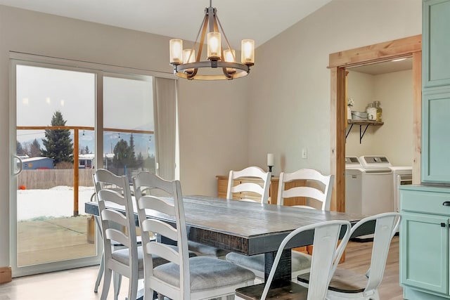 dining area featuring an inviting chandelier, washer and clothes dryer, and light hardwood / wood-style floors