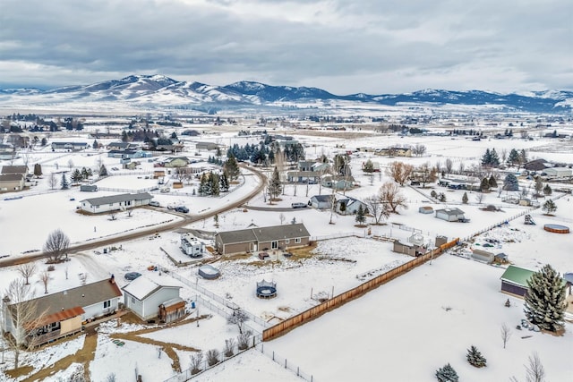 snowy aerial view featuring a mountain view