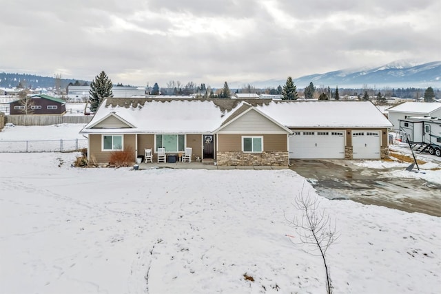 view of front of property with a garage and a mountain view