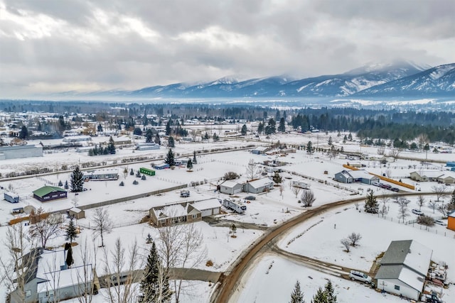 snowy aerial view featuring a mountain view