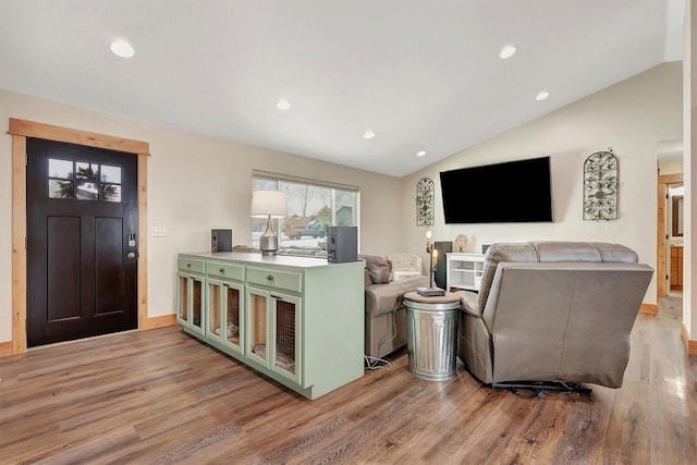 living room with vaulted ceiling and light hardwood / wood-style floors