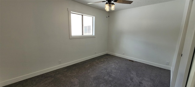 carpeted spare room with ceiling fan and a textured ceiling