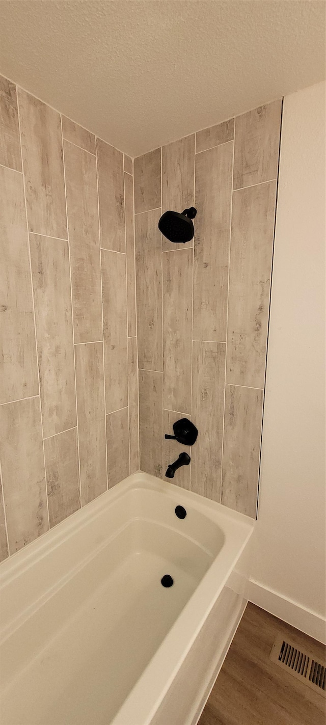 bathroom featuring hardwood / wood-style flooring and a textured ceiling