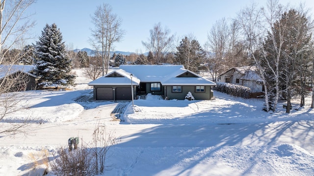 view of front of home with a mountain view and a garage