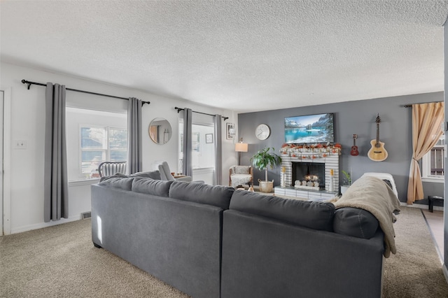 carpeted living room featuring a textured ceiling and a fireplace