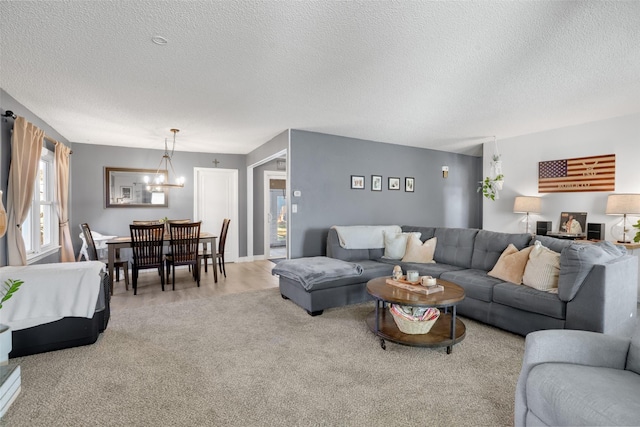 living room featuring an inviting chandelier and a textured ceiling