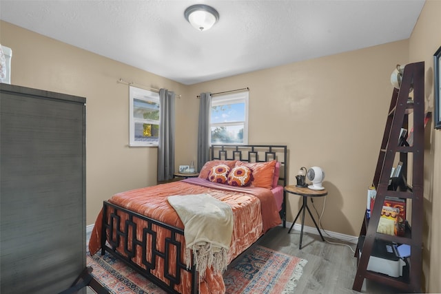 bedroom with wood-type flooring