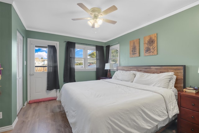 bedroom with wood-type flooring, ceiling fan, and crown molding