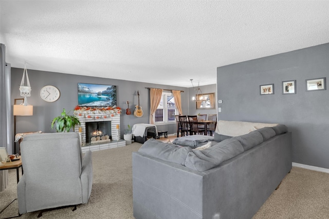 carpeted living room featuring a brick fireplace and a textured ceiling