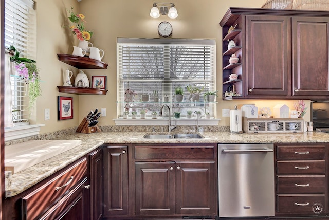 kitchen with sink, stainless steel dishwasher, and light stone counters