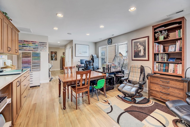 dining space with light hardwood / wood-style floors