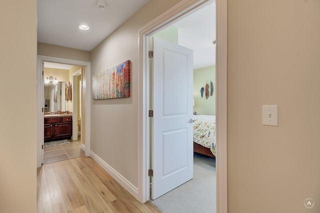 corridor with light hardwood / wood-style floors