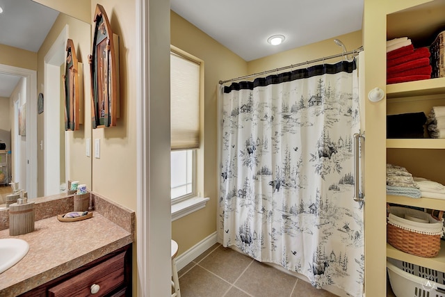 bathroom featuring tile patterned flooring, vanity, a shower with shower curtain, and toilet