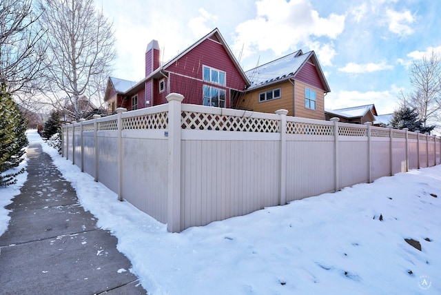 view of snow covered rear of property