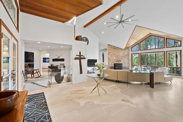 living room with wood ceiling, a fireplace, high vaulted ceiling, and beamed ceiling