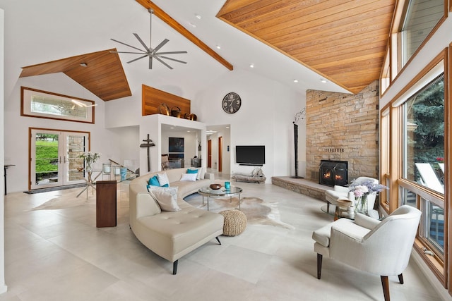 living room with french doors, a stone fireplace, high vaulted ceiling, wooden ceiling, and ceiling fan