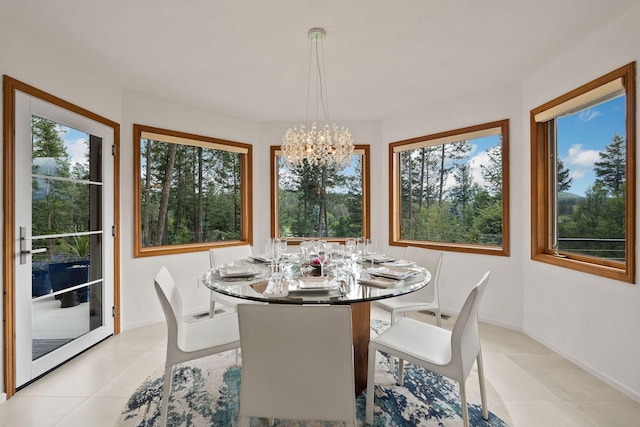 dining space featuring a wealth of natural light, light tile patterned floors, and a notable chandelier