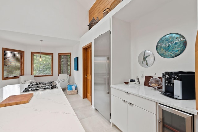 kitchen featuring white cabinets, hanging light fixtures, wine cooler, and stainless steel appliances