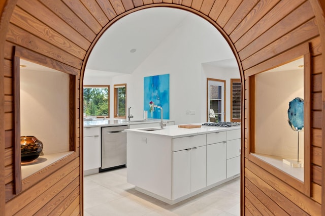 bathroom featuring tile patterned floors, vanity, and vaulted ceiling