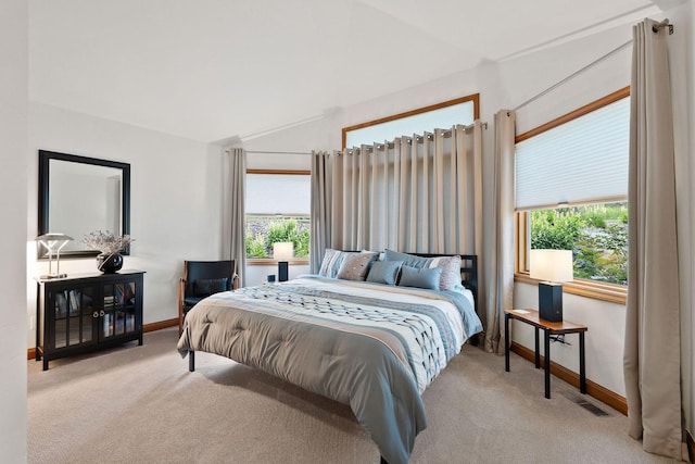 carpeted bedroom featuring lofted ceiling