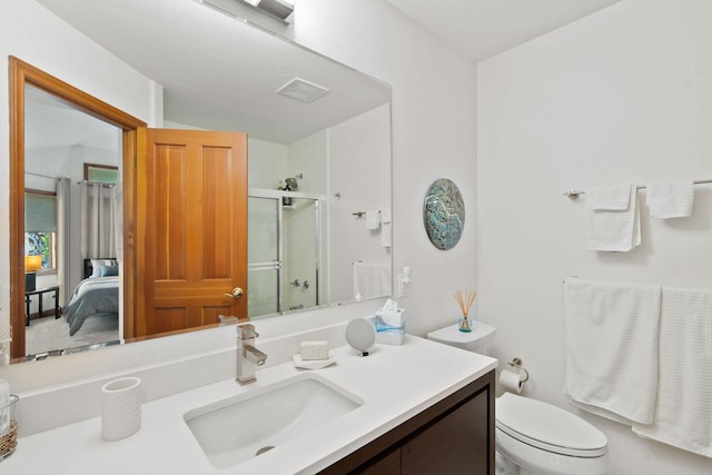 bathroom featuring vanity, toilet, and walk in shower