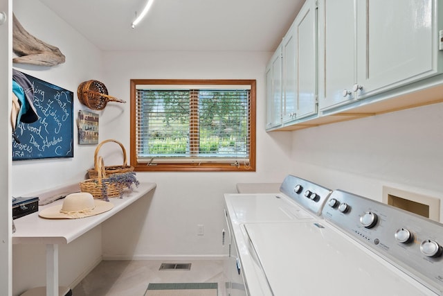 laundry area with cabinets and washing machine and dryer