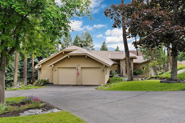 view of front of house with a garage and a front yard