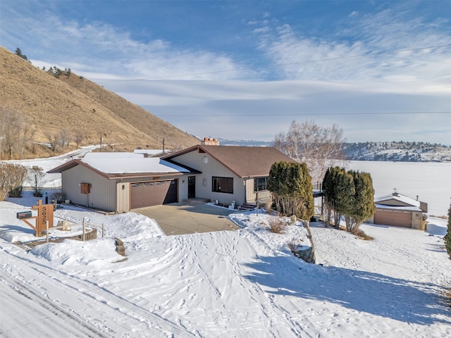 ranch-style house with a mountain view and a garage