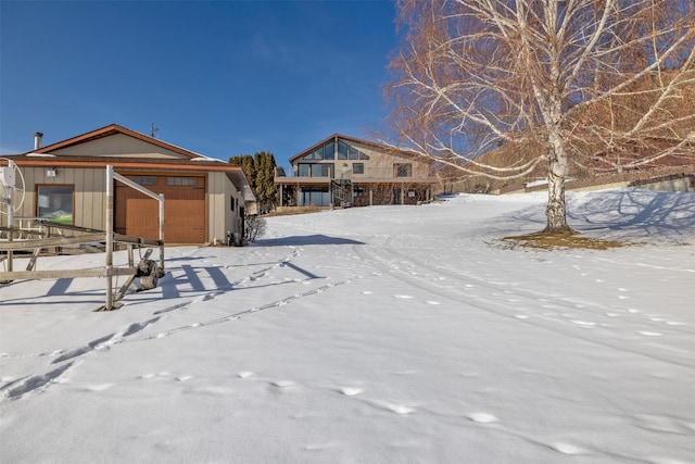 yard layered in snow with a garage