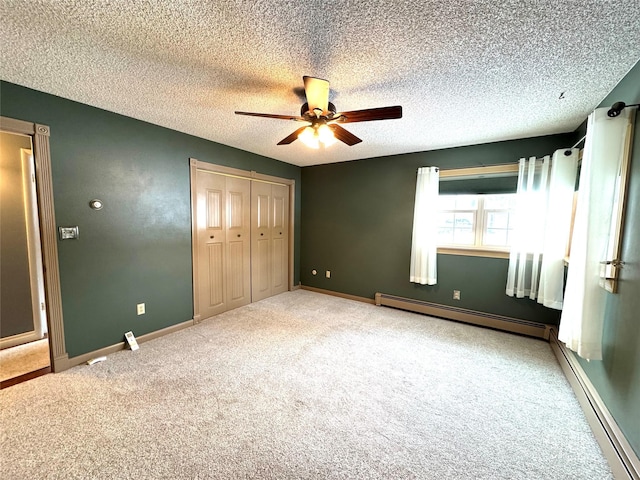 unfurnished bedroom with a baseboard radiator, carpet floors, a textured ceiling, and a closet