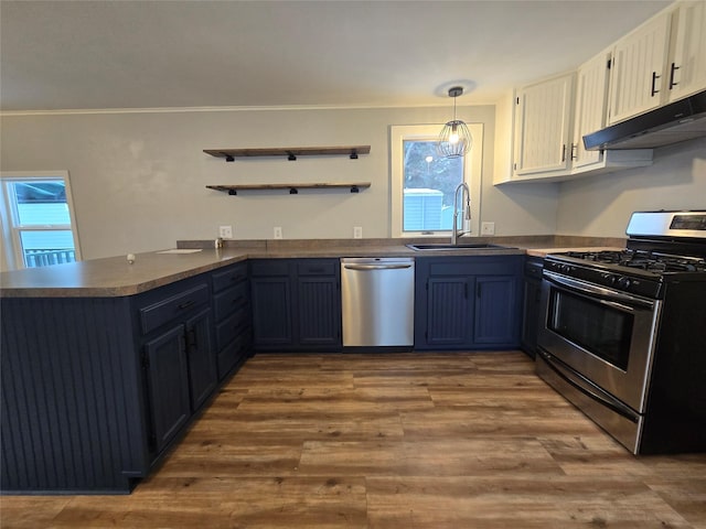 kitchen featuring appliances with stainless steel finishes, sink, white cabinets, hanging light fixtures, and kitchen peninsula