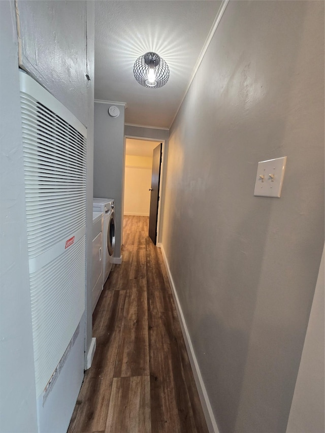 hallway featuring crown molding, washing machine and clothes dryer, and dark hardwood / wood-style flooring