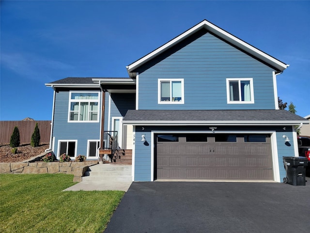 view of front of home with a garage and a front yard