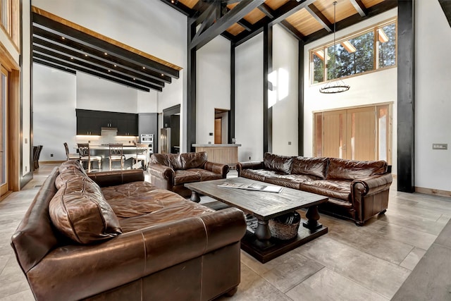 living room featuring beam ceiling and a high ceiling