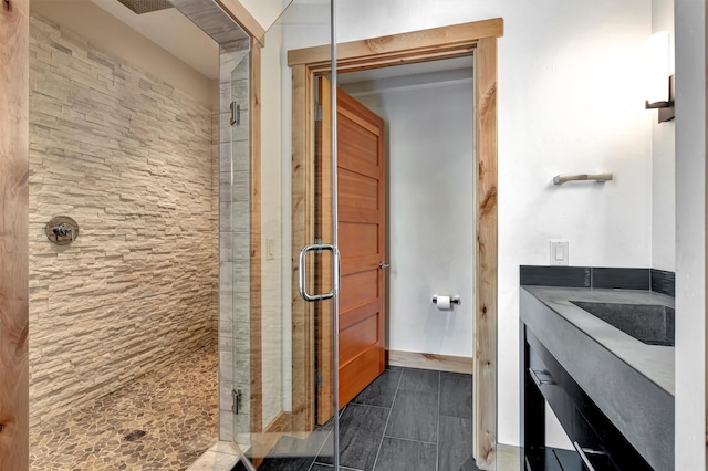 bathroom with sink and a shower with shower door